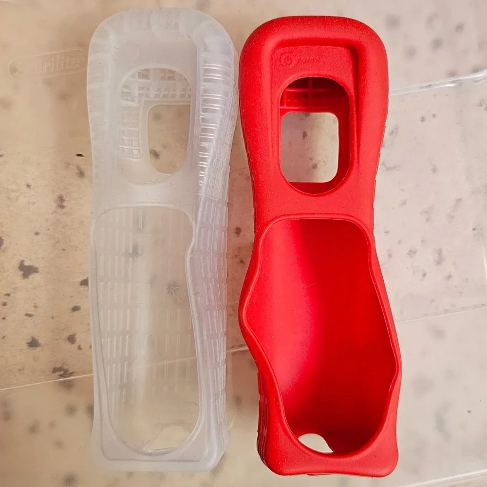 2 Wii silicone controller cases, EUC condition, OEM Nintendo, 1 red, 1 clear